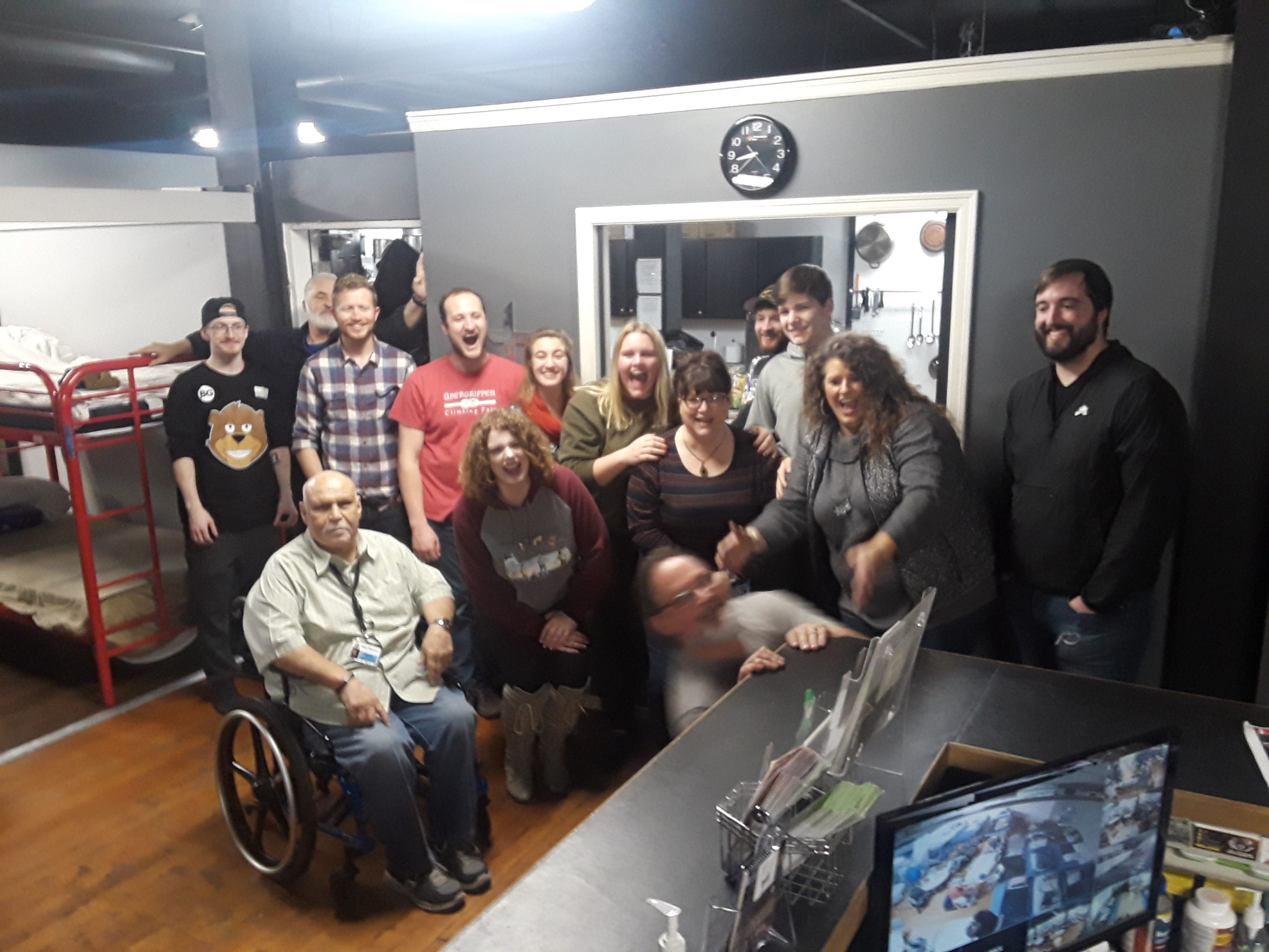 A group of people in a room with a tv.