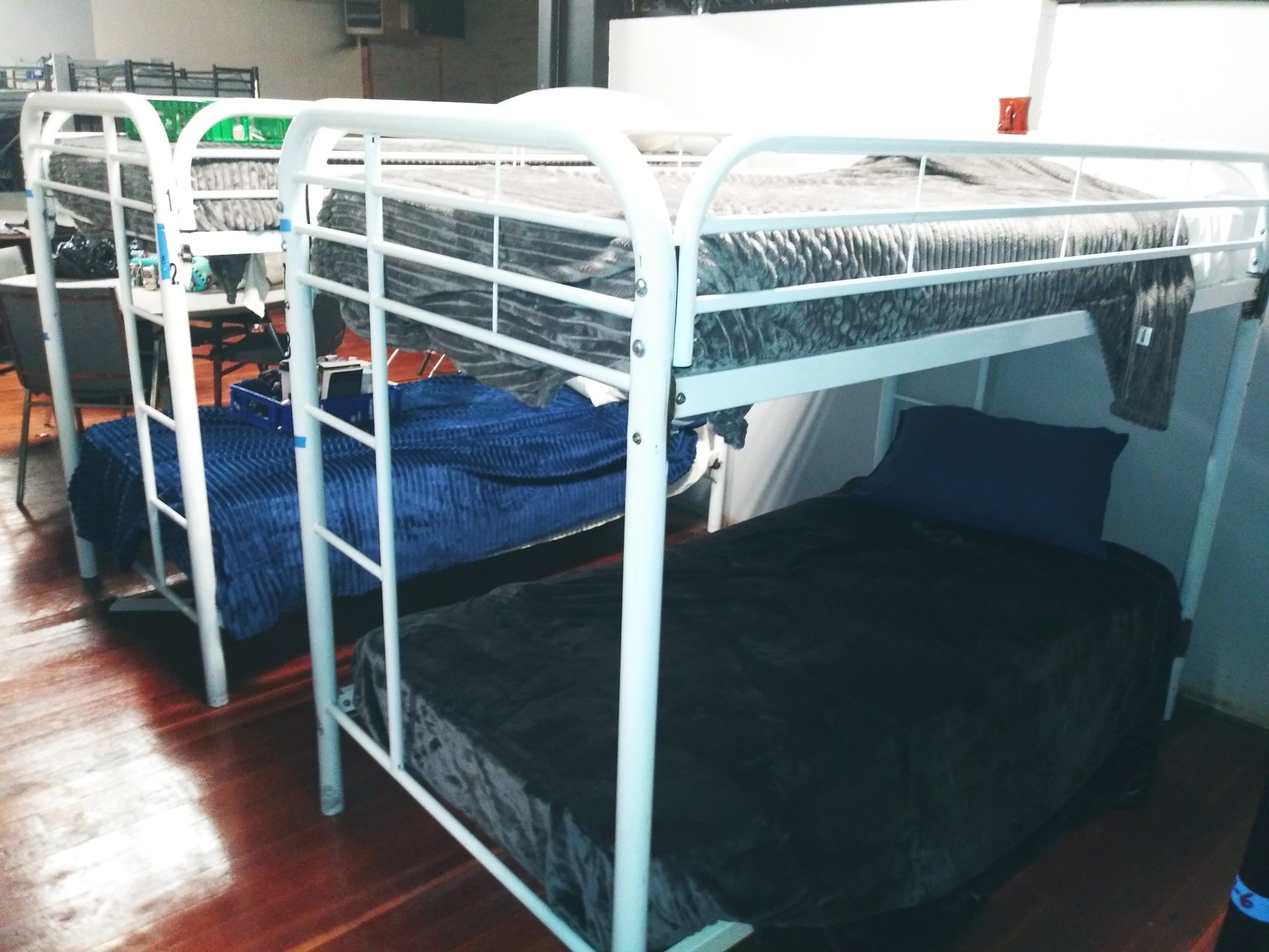 A room with bunk beds and futon in it